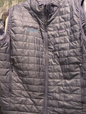 patagonia vest embroidered with navy seal foundation logo. size xxl. blue/gray.